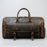 Dark Brown leather duffel bag with gold buckles on a textured gray background