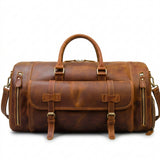 Brown leather duffel bag with gold buckles